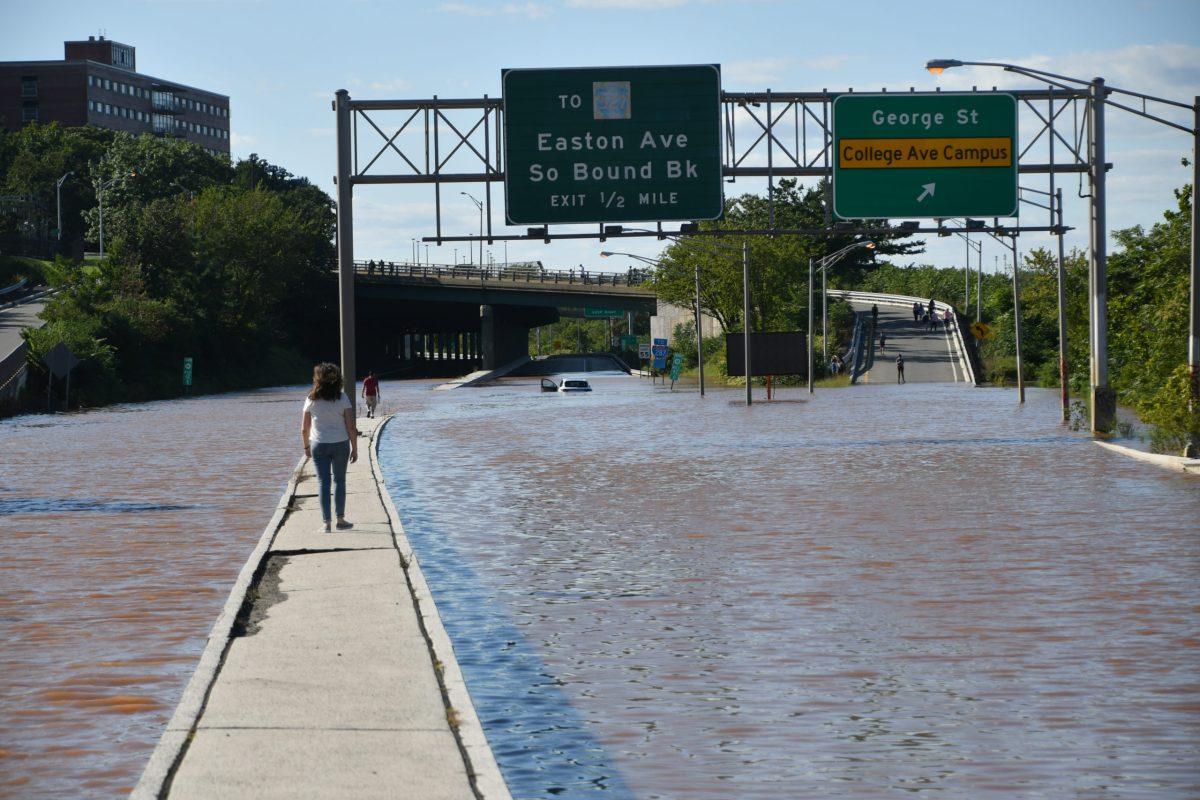 Woman+walks+on+median+in+the+middle+of+a+flooded+route+18+highway+in+New+Brunswick%2C+NJ+after+Hurricane+Ida.+New+Brunswick%2C+NJ+USA+-+September+2%2C+2021%3A+City+of+New+Brunswick+flooded+after+Hurricane+Ida.